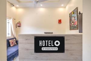 a hotel sign on a counter in a room at Super Hotel O Clock Tower Dehradun Formerly Dooncity Suites in Dehradun