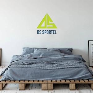 a bed with a us pyramid sign on the wall at DS Sport Hostel in Ko Lanta