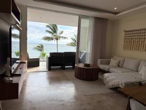 a living room with a couch and a view of the ocean at Luxury by the sea unmatched comfort in Bucerías +82 photos