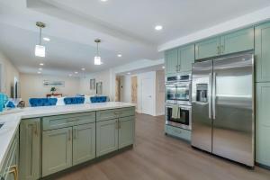 a kitchen with green cabinets and stainless steel appliances at Hey I Am Adriana On The Block Pool BBQ in Mission Viejo