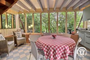 a kitchen with a table and chairs in a room at Ker desiree in Plélo