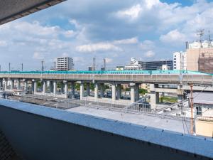 a bridge over a city with a train station at FLEXSTAY INN Higashi Jujo in Tokyo
