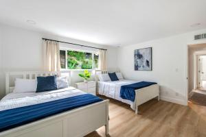 a bedroom with two beds and a window at Lux MV Home Live Like A Local Backyard Oasis in Mission Viejo +23 photos