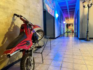 a red motorcycle is parked in a hallway at Premium Stay Academy - Luxus-Ferienwohnungen mit Erlebnis in Bad Ems