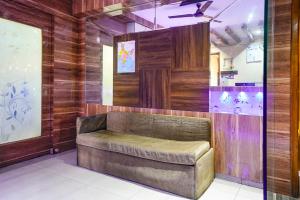 a leather bench in a room with wooden walls at Via New Silver Elite in Mumbai