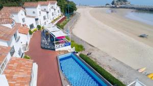 a view of the beach from a house with a swimming pool at Namhae Melody Kids Private Pension in Sukho
