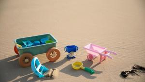 a toy train on the sand on a beach at Namhae Melody Kids Private Pension in Sukho