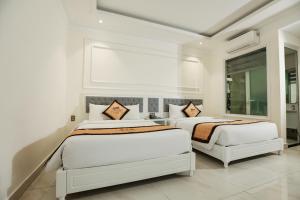 Postel nebo postele na pokoji v ubytování Le Marais Hotel Dalat + 107 fotografií