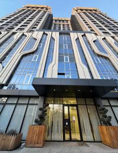 a tall building with a lot of windows at Bright & Airy Apartment in Central Bishkek in Bishkek