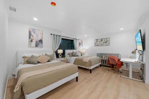 a white bedroom with two beds and a desk at Entire Private Pool, Big Yard, View, 4BR, King Bed, 10 Parking, Available Now in El Cajon +96 photos