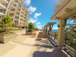 a balcony of a building with a table and chairs at 2-BR Condo near Major Tourist Spots in Baguio in Sampong