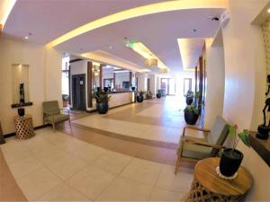 an empty lobby with chairs and a table in a building at 2-BR Condo near Major Tourist Spots in Baguio in Sampong