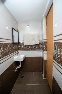 a bathroom with a sink and a shower at Cozy 2BR in Chennai