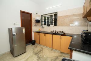 a kitchen with a stainless steel refrigerator and a sink at Cozy 2BR in Chennai +40 photos