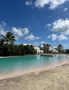 een groot zwembad met een resort op de achtergrond bij A chic apartment by Afra Paje in Paje