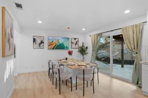 a white dining room with a table and chairs at Entire Private Pool, Big Yard, View, 4BR, King Bed, 10 Parking, Available Now in El Cajon
