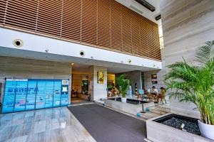 een lobby van een gebouw met mensen aan tafel bij Aixin Yangtze River International Apartment in Chongqing