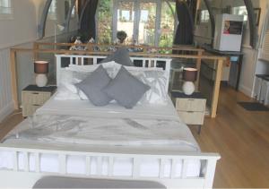 a bedroom with a white bed with pillows at SEAVIEWS Oak Beach in Oak Beach