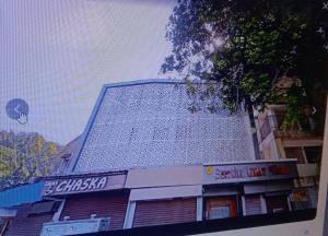a building with a sign on the side of it at Sapphire Guest House in Kolkata