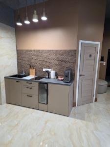 cocina con encimera, fregadero y puerta en Vinetas Apartments Nr3 The One, en Cēsis 15 fotos más