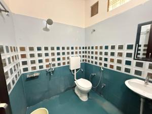 a bathroom with a toilet and a sink at Hotel O stay inn in Shivāpur