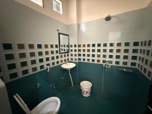 a bathroom with a toilet and a sink at Hotel O stay inn in Shivāpur
