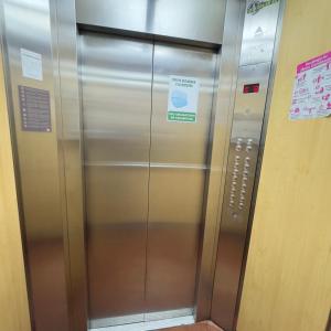 an elevator in a building with a sign on it at Mirador Inn in Pasto