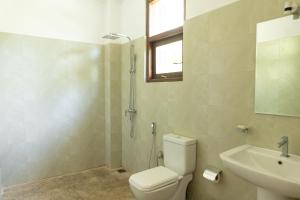 a bathroom with a toilet and a sink and a shower at Hotel Siyomin in Ahangama +9 photos