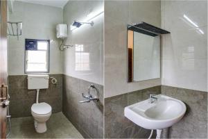 a bathroom with a sink and a toilet and a mirror at FabHotel Golden Heights in Hinjewadi