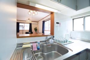 a kitchen with a sink and a counter at MATATABI STAY Tenroku w8 in Osaka