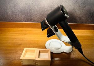 a blow dryer sitting on top of a wooden table at Ishibekoji Muan in Kyoto