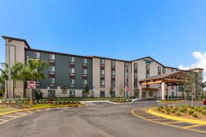 a large building with a street in front of it at WoodSpring Suites Tamarac in Tamarac