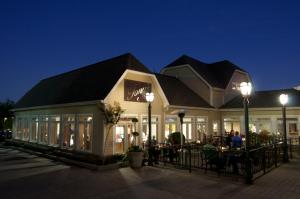 a building with people sitting at tables outside at night at Bluff View Inn in Chattanooga