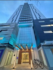 a tall building with bikes parked in front of it at One Million-Dollar Vista Premium 2-Bed Sky Flat with Lake & City Views in Kelowna