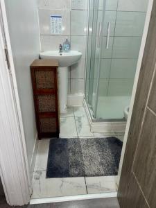 a small bathroom with a sink and a shower at Family Room on Green road in Dudley