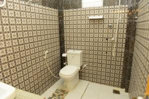 a bathroom with a toilet and a shower at Royal Beach Hotel in Trincomalee
