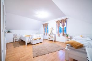 a bedroom with white walls and wooden floors at Old Village House in Suza