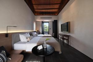 una habitación de hotel con dos camas y una mesa en Sunset Garden Hotel, en Gulang Yu 92 fotos más