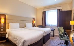 a hotel room with two beds and a window at Premier Inn Dubai Al Jaddaf - An Emirates Group Company in Dubai +37 photos