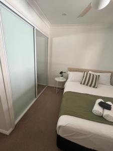 a bedroom with a bed and a large window at Double room with shared bathoom in Auburn