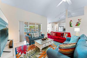 a living room with blue and red couches at 306 Jack Drive in Cocoa Beach