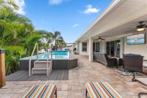a patio with a pool and chairs and a house at 306 Jack Drive in Cocoa Beach