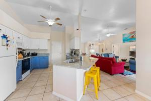 a kitchen and living room with a red couch at 306 Jack Drive in Cocoa Beach