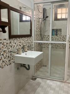 a bathroom with a white sink and a shower at Pearl Nest in Galle +79 photos