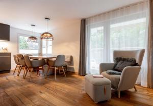 a living room with a dining room table and chairs at Alpine Lodge 63 in Andermatt