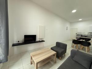 a living room with a couch and a table and chairs at Suite For 5pax The Anderson Residence Ipoh #57 in Ipoh