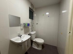 a white bathroom with a toilet and a sink at Suite For 5pax The Anderson Residence Ipoh #57 in Ipoh