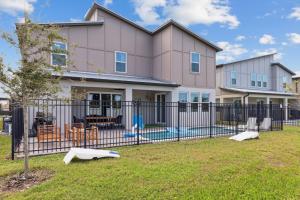 a house with a fence and a playground at Beachside Deluxe in Melbourne Beach