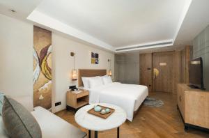 a hotel room with a bed and a tv at LN Hotel Five-Canton Fair Free Shuttle Bus & Free Snack in Guangzhou