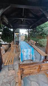 a group of wooden benches sitting under a roof at Daniel Studios in Kallithea Halkidikis